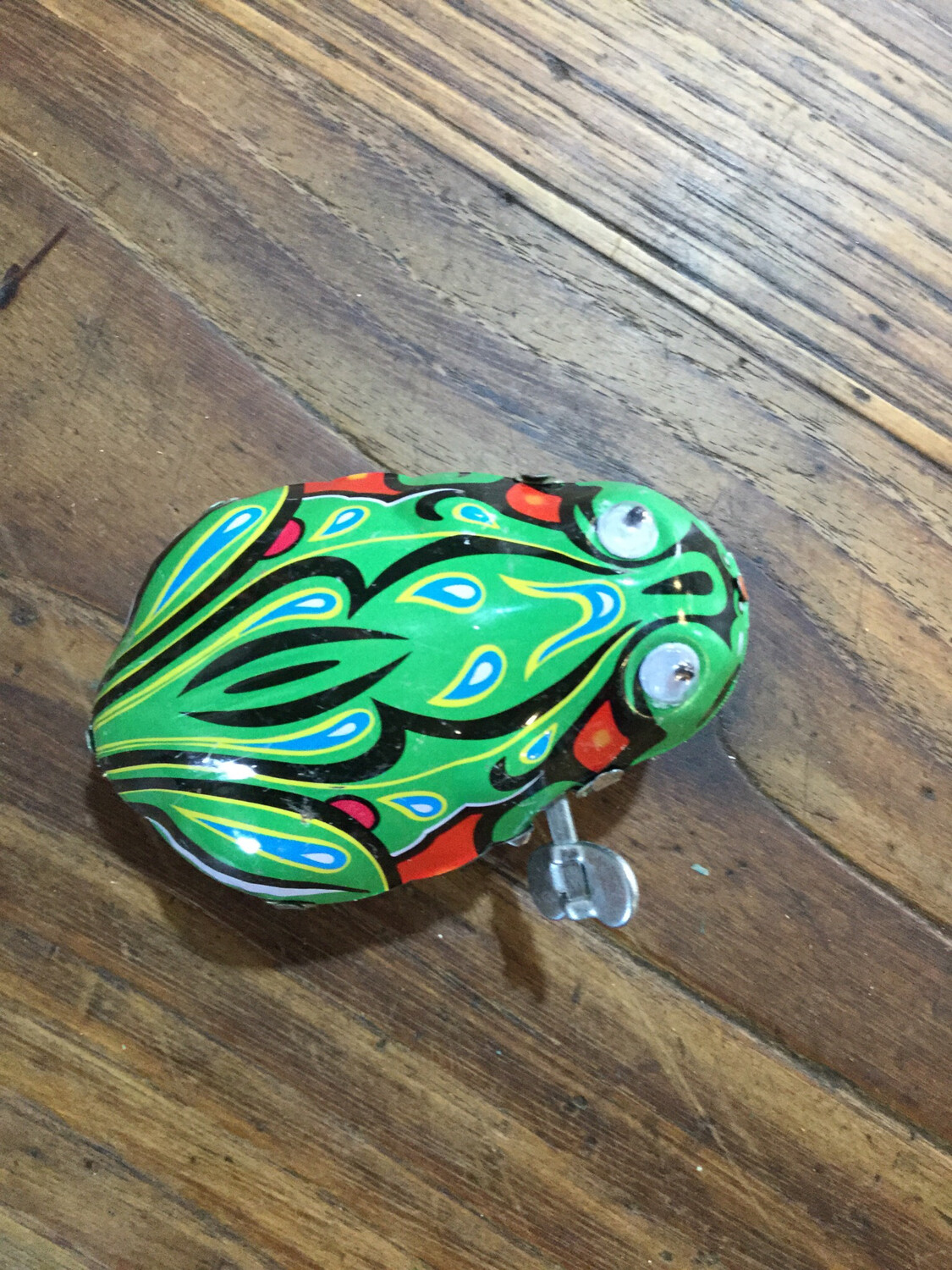 Clockwork windup frog , wind-up Tin toy frog . Hopping Tin Frog