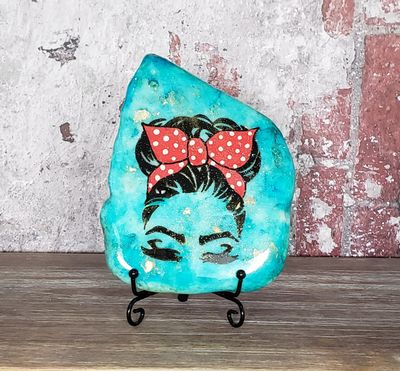 Blue girl with red ribbon painted stone