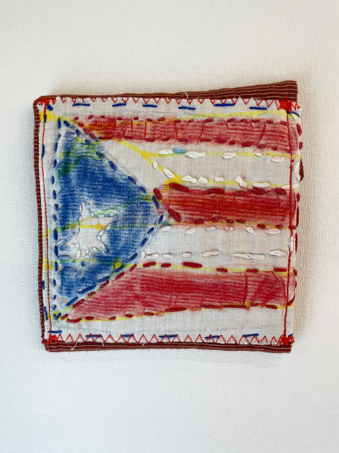 embroidered Puerto Rican flag wallet by Keishla Rosado