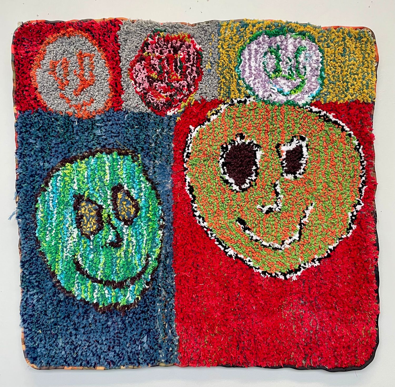Smiley Faces tufted wall hanging by Ania Lattie