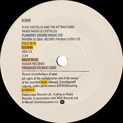 Elvis Costello &amp; The Attractions - Radio Radio (7&quot;, Single, Com) (Very Good Plus (VG+))