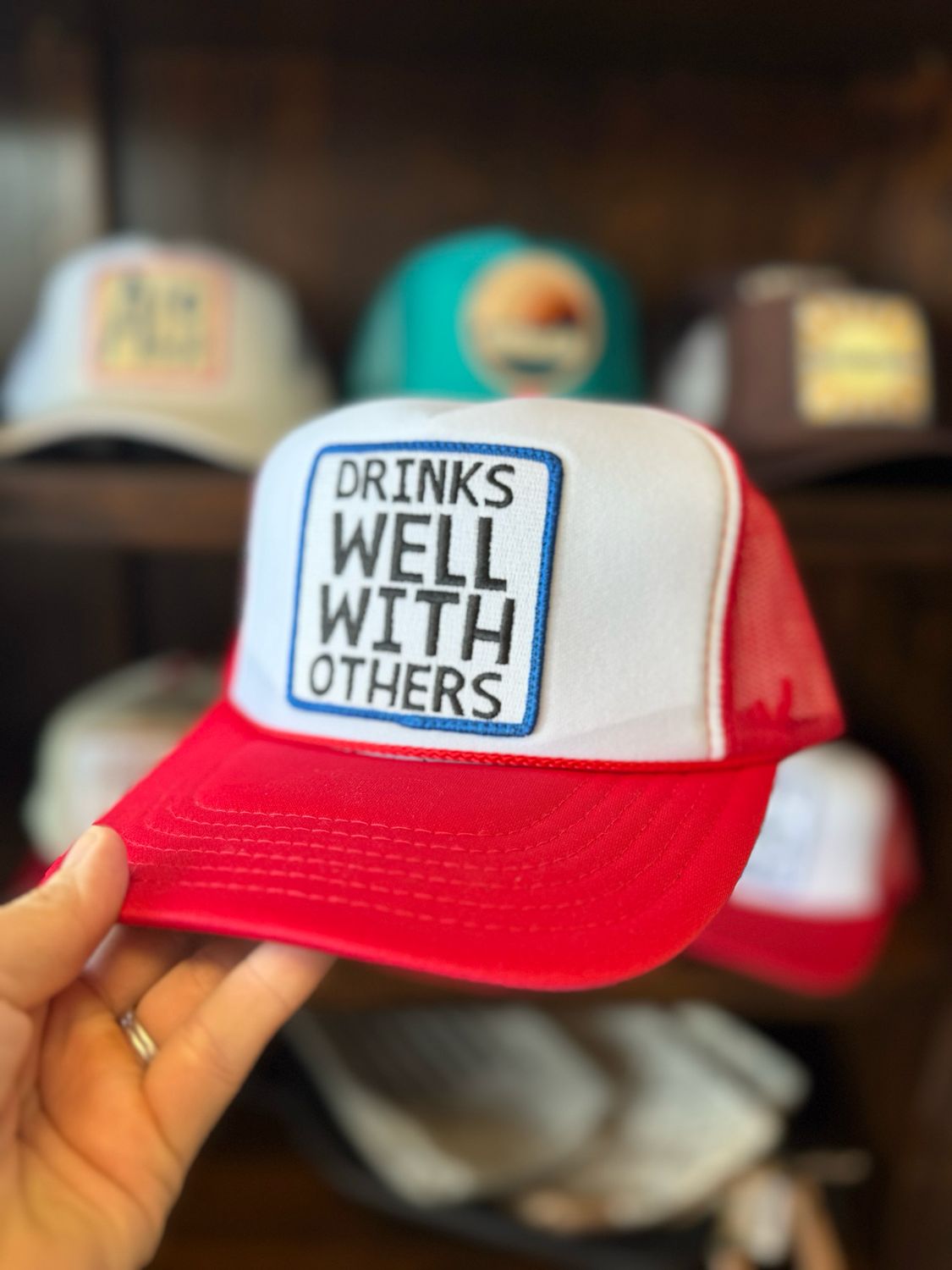 Drinks Well With Others Trucker Hat