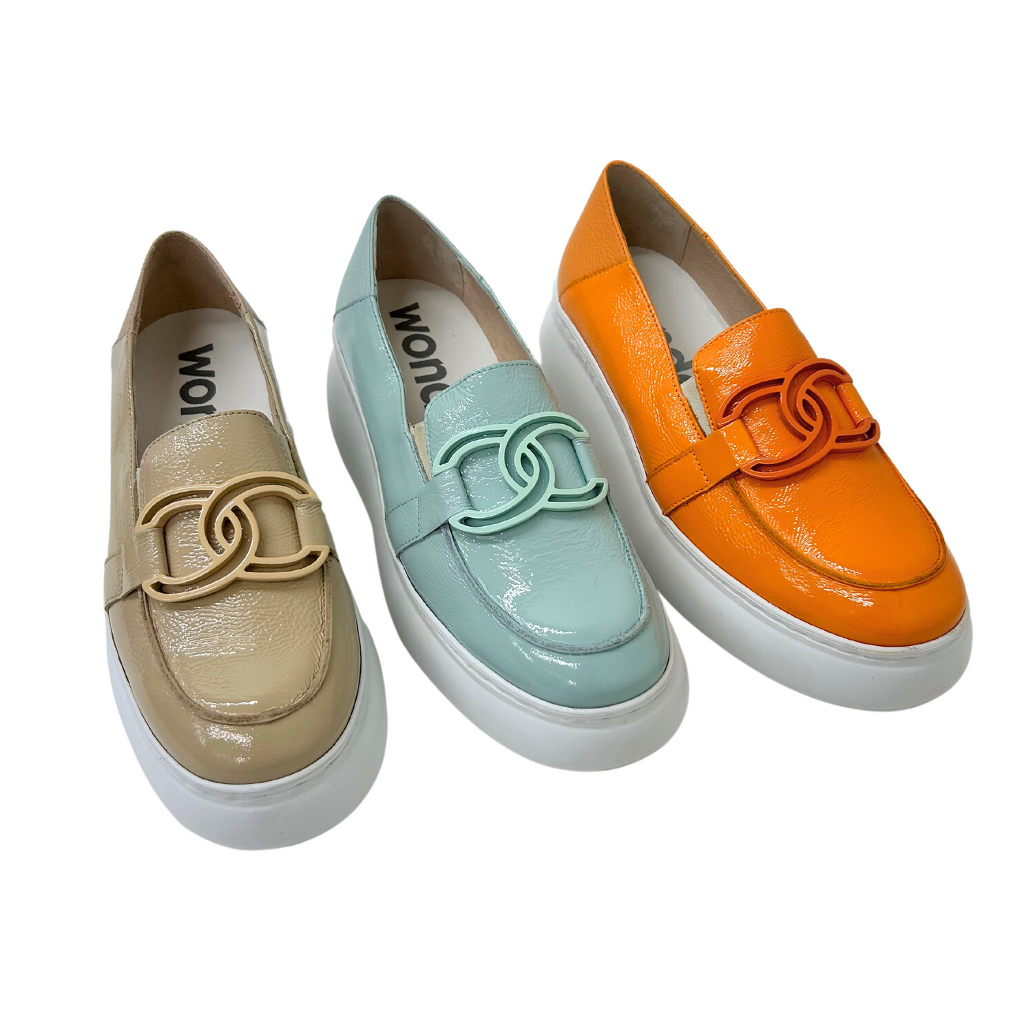 Patent leather loafer shown in 3 colors options - taupe, blue/green and apricot.  All with white soles