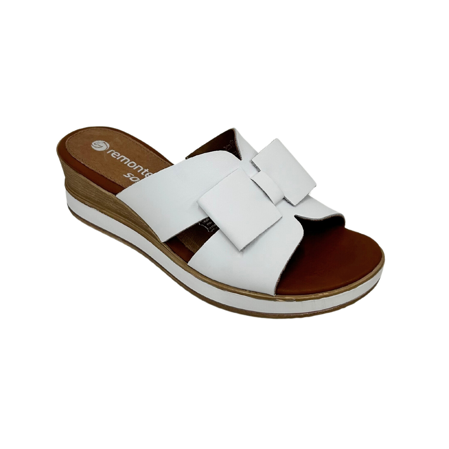 Angled view of white leather mule.  Open toe and wedge heel