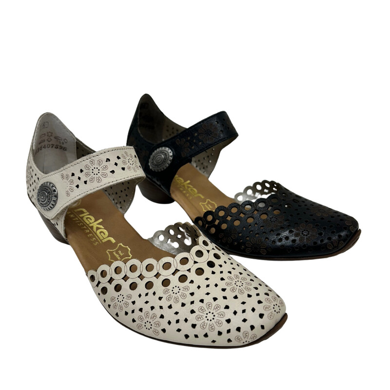 A summer shoe with closed toe and heel.  Laser cut outs across front and on strap at top of foot.   Shown in black and cream