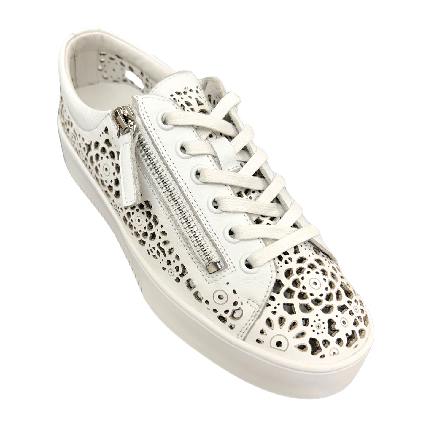 Angled front view of a white leather sneaker with laser cut outs.  Laces down front as well as a zipper on the outside.