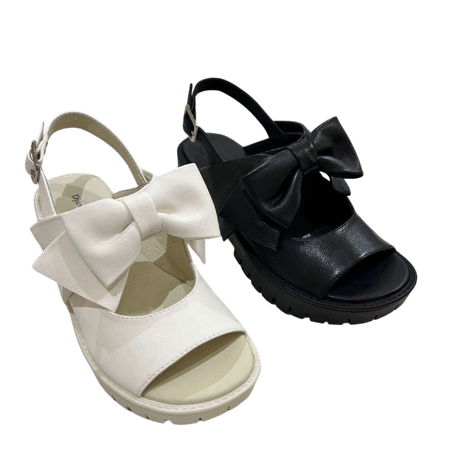 Angled front view of a leather sandal with large bow.  Shown in both black and white