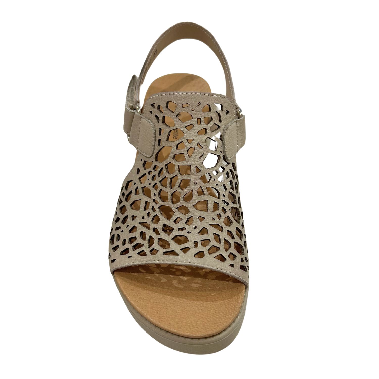 Front view of an almond colored leather sandal with laser cut outs.