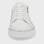 Front view of a white leather sneaker with soft gold piping around the outsole and white laces.