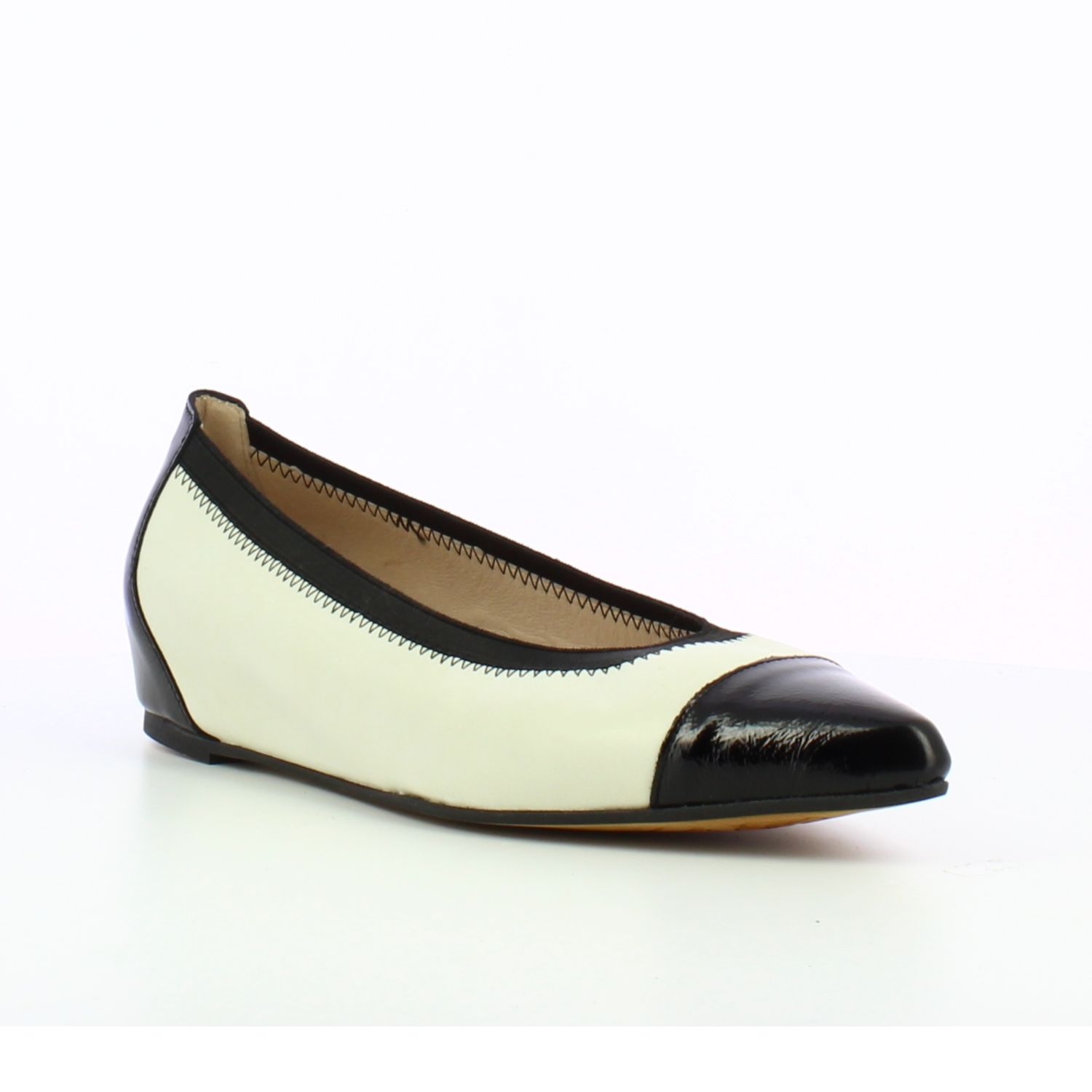 Angled front view of a classic ballet flat in a cream and black.