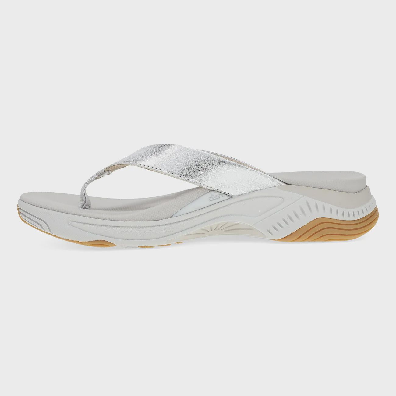 Inside view of a beach, toe post sandal in a silver leather.  Shop Dansko