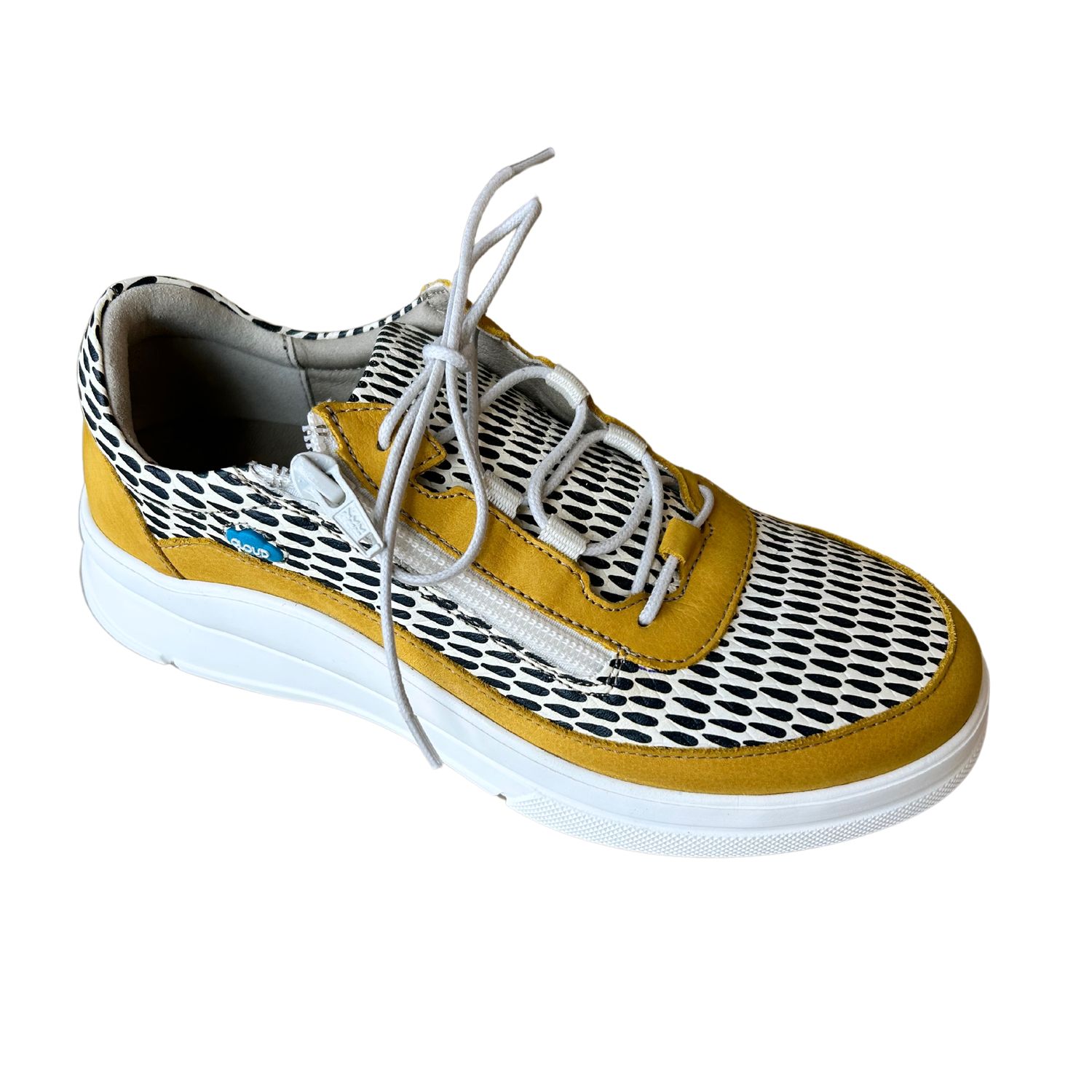 Angled front view of a sneaker with golden yellow leather trim around the outsole and laces.  Balance of upper is white with perforations.  White sole.