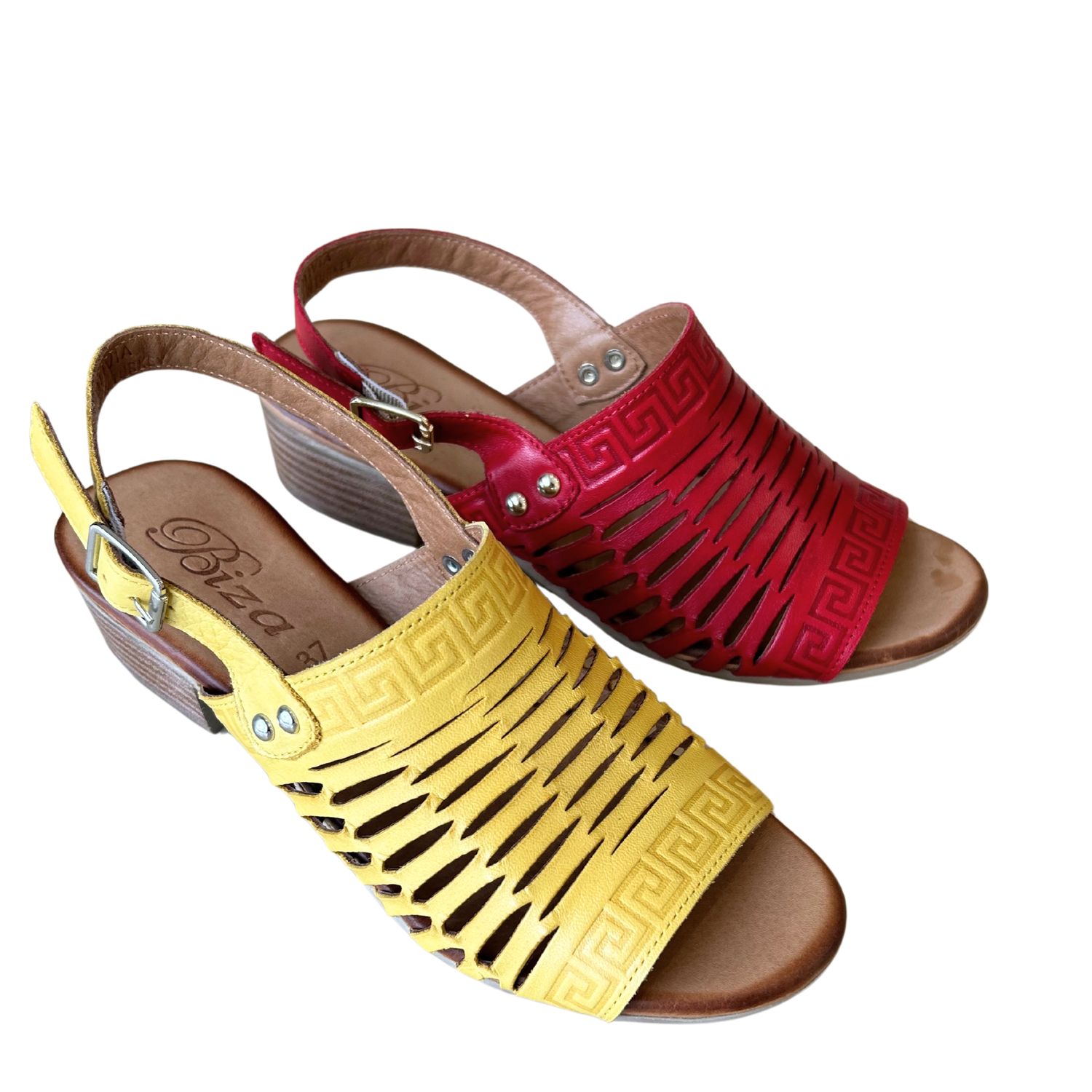A photo of a leather sandal in a bright yellow and a red.
