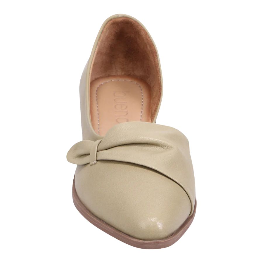 Front view of a cream colored summer flat.  Closed toe and heel but features a cut out at the arch.