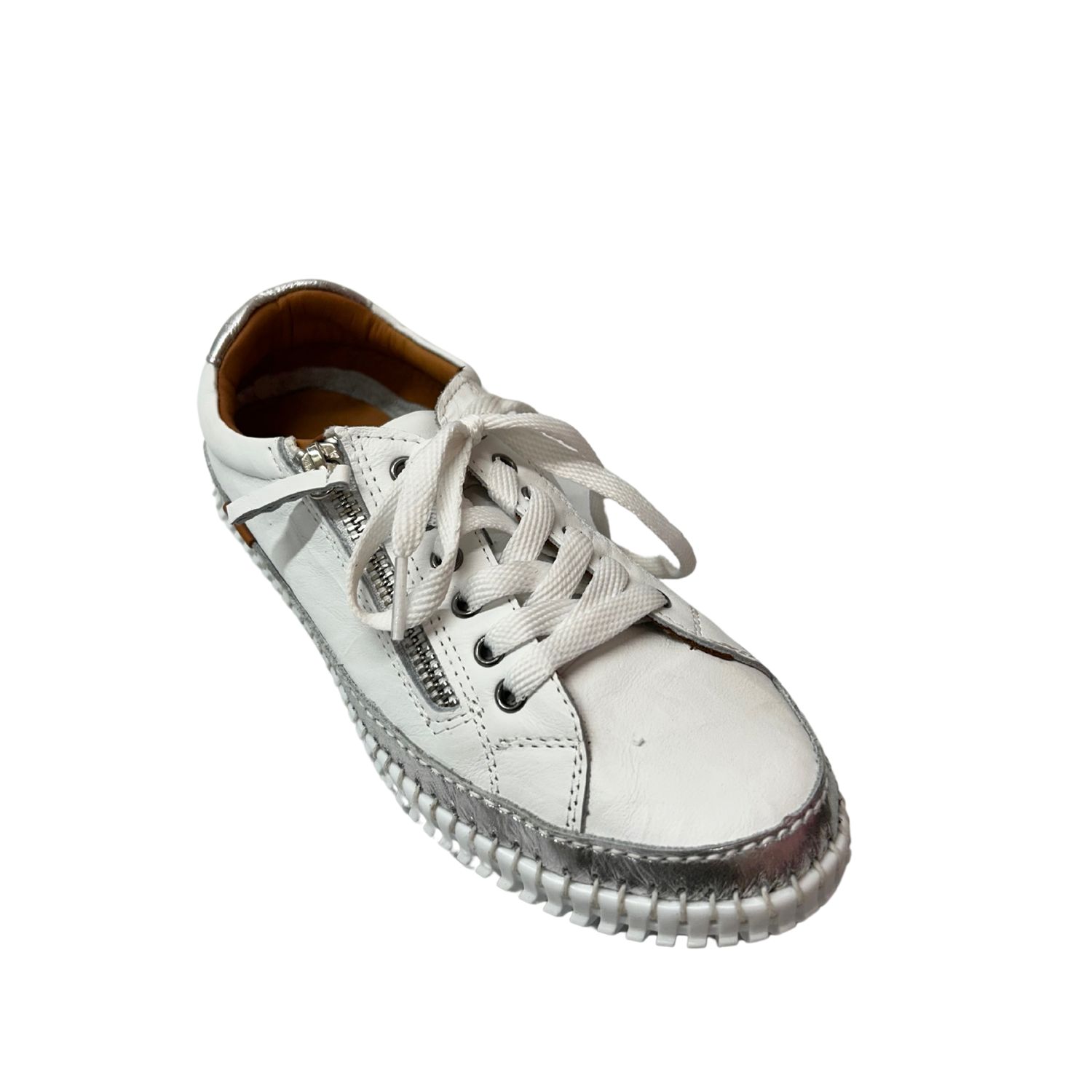 Angled front view of a white leather sneaker with a silver stripe along the outsole.