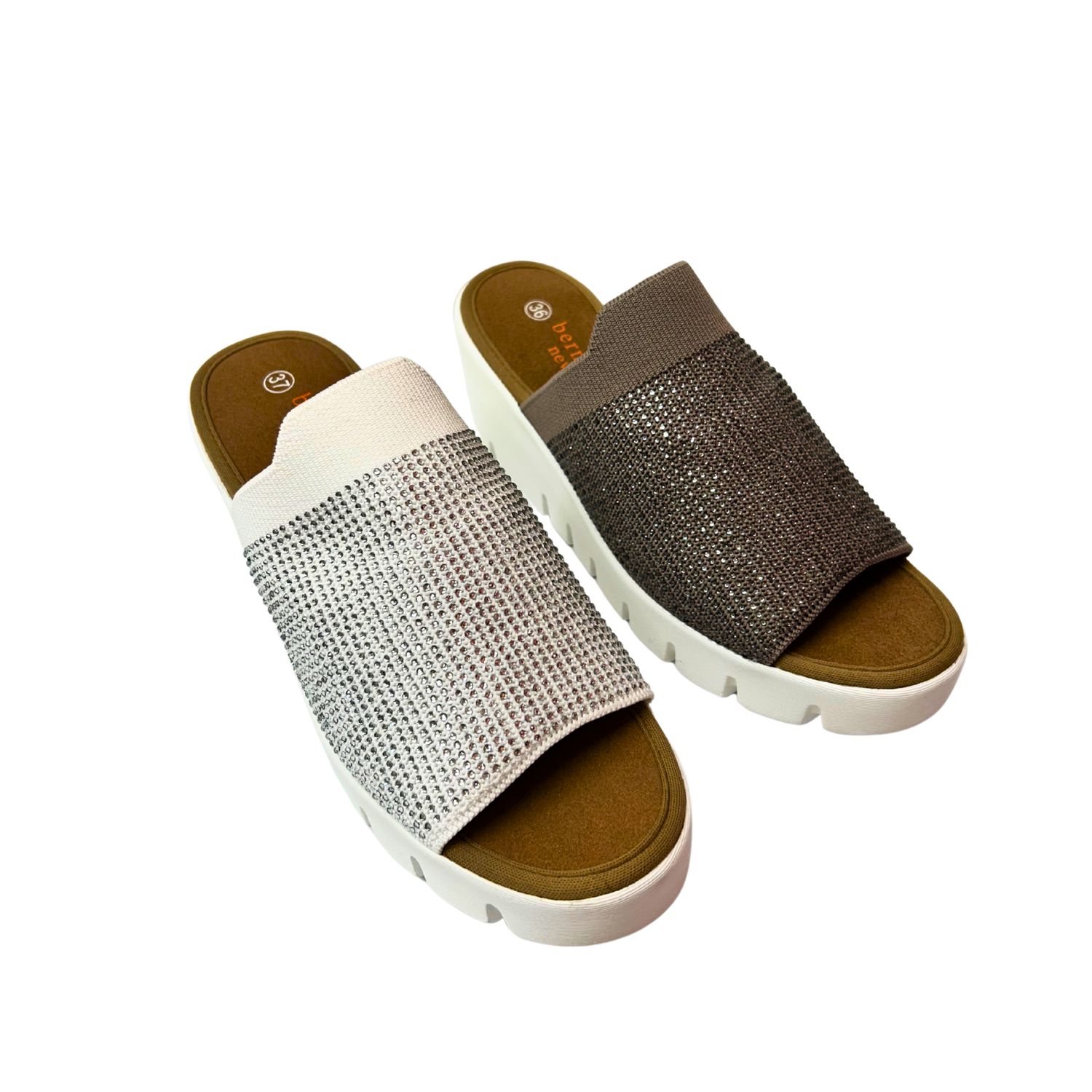 Angled front view of a wedge sandal.  Upper is an elasticized textile with little embedded crystals.  Shown in a white and taupe.