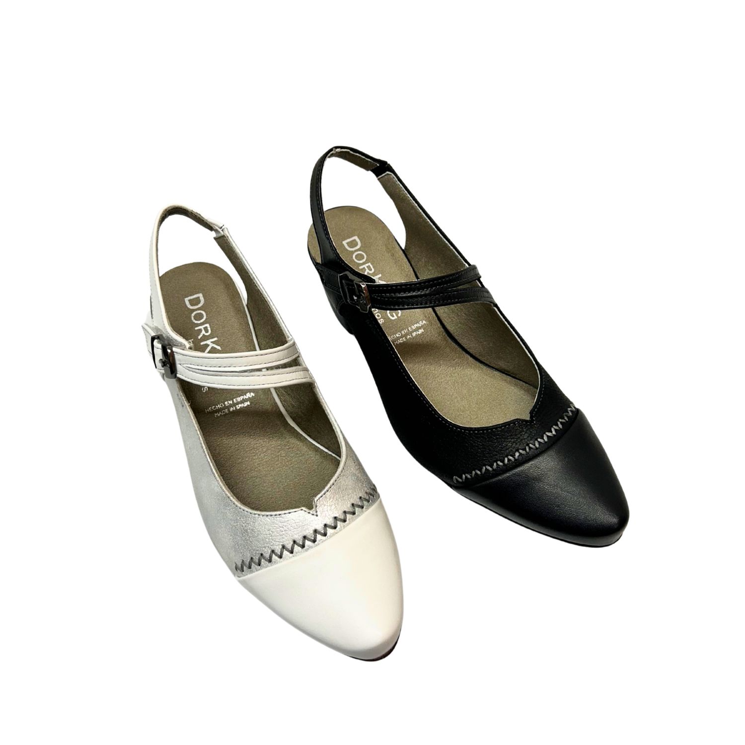 Angled front view of a open heel pump from Fluchos.  Cross strap is adjustable.  Shown in both a white/silver and black.