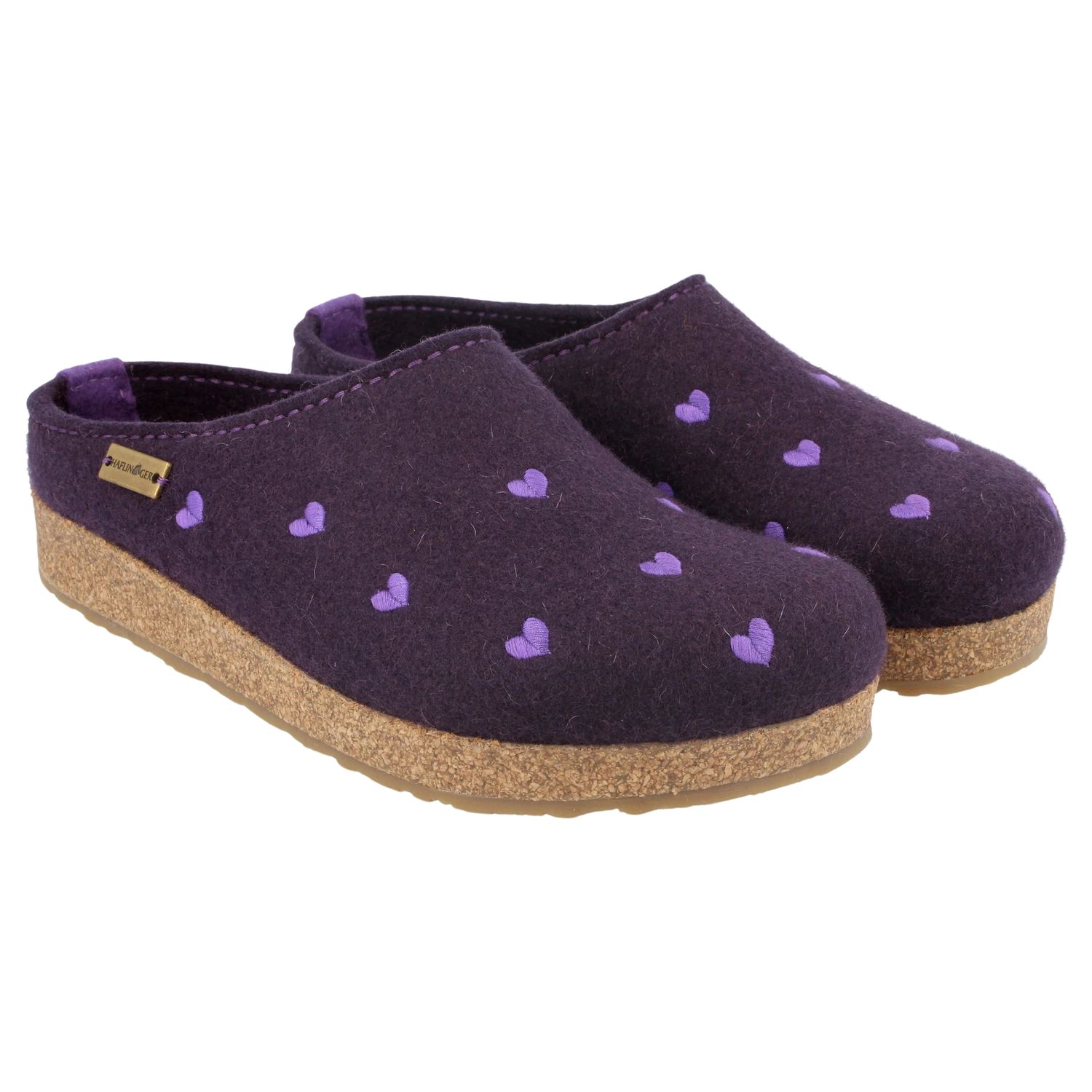 Pair of boiled wool slippers.  They are purple with little pink hearts on them.