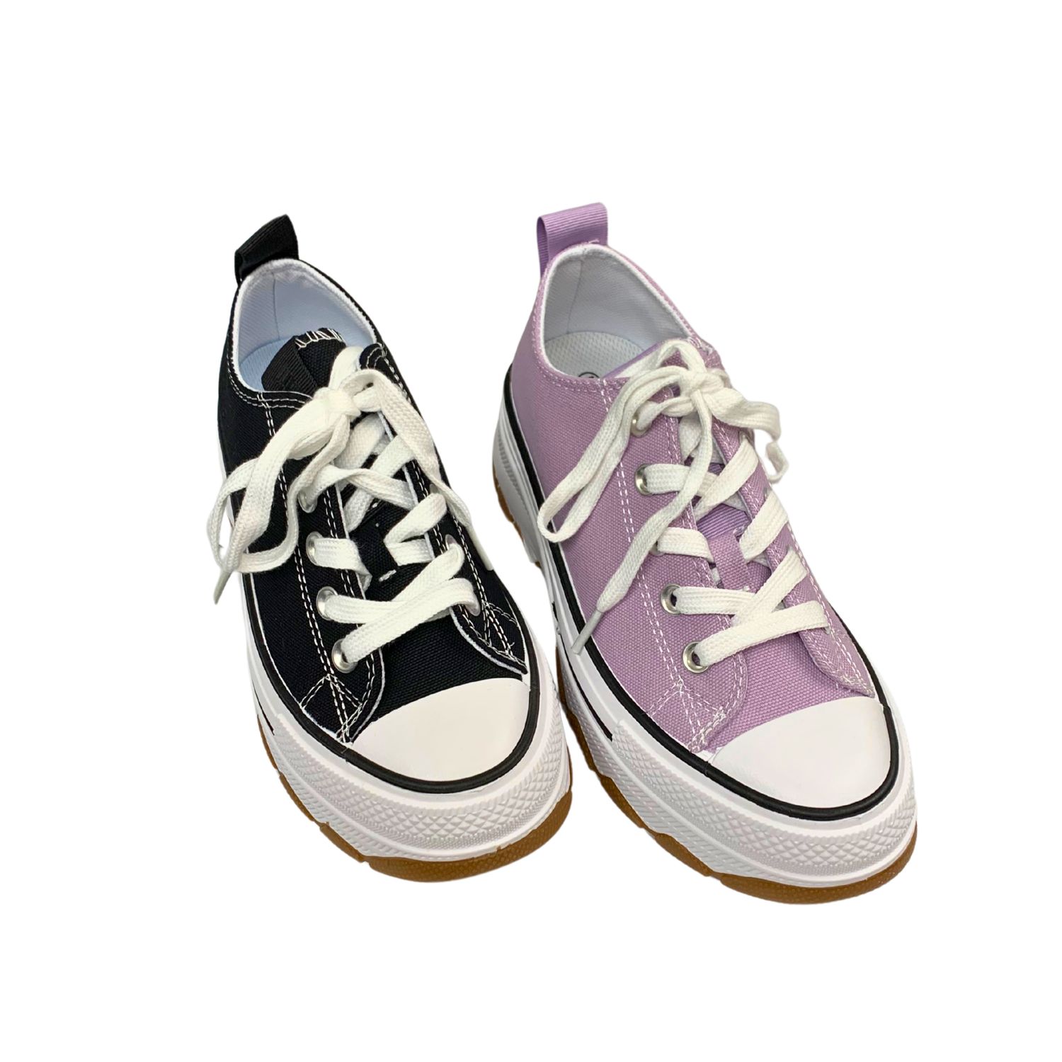 Canvas sneaker with a doubled up sole shown in a lilac and a black color.