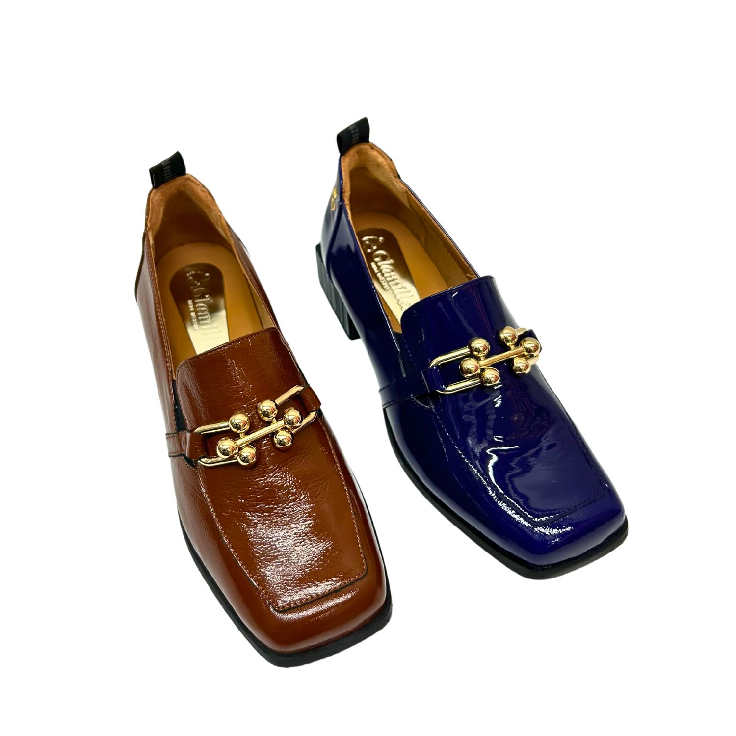 Angled front view of a classic patent leather loafer with a detailed, gold metallic bar across the top.  Shown in a cognac color (marron) and a blue (oceano).