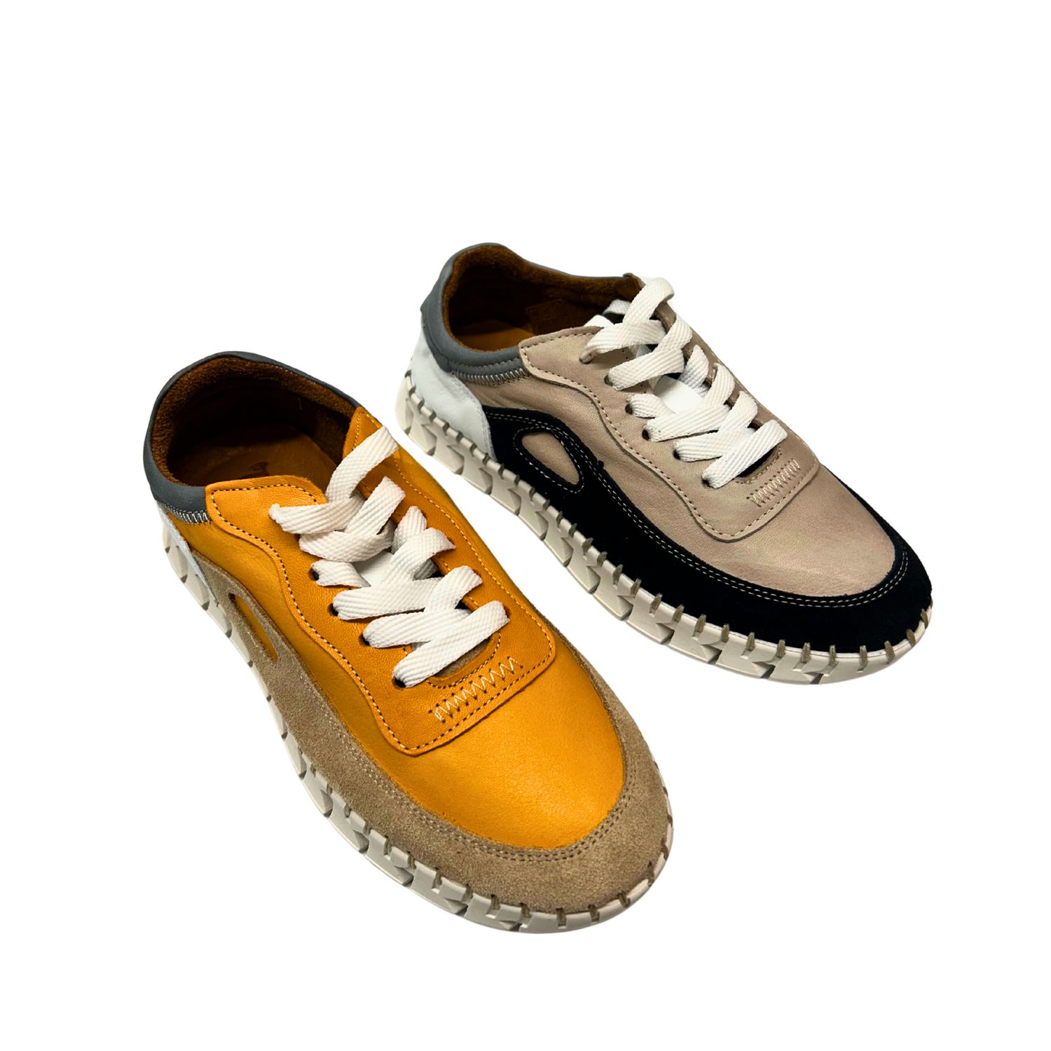 A fashion sneaker that almost feels like a loafer.  Shown in a navy/taupe and a yellow.  Both with white laces.