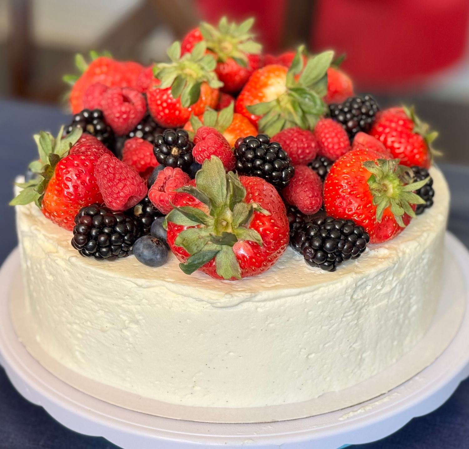 9-inch keto Chantilly cake with vanilla whipped cream frosting, topped with strawberry, blueberry, blackberry, and raspberry