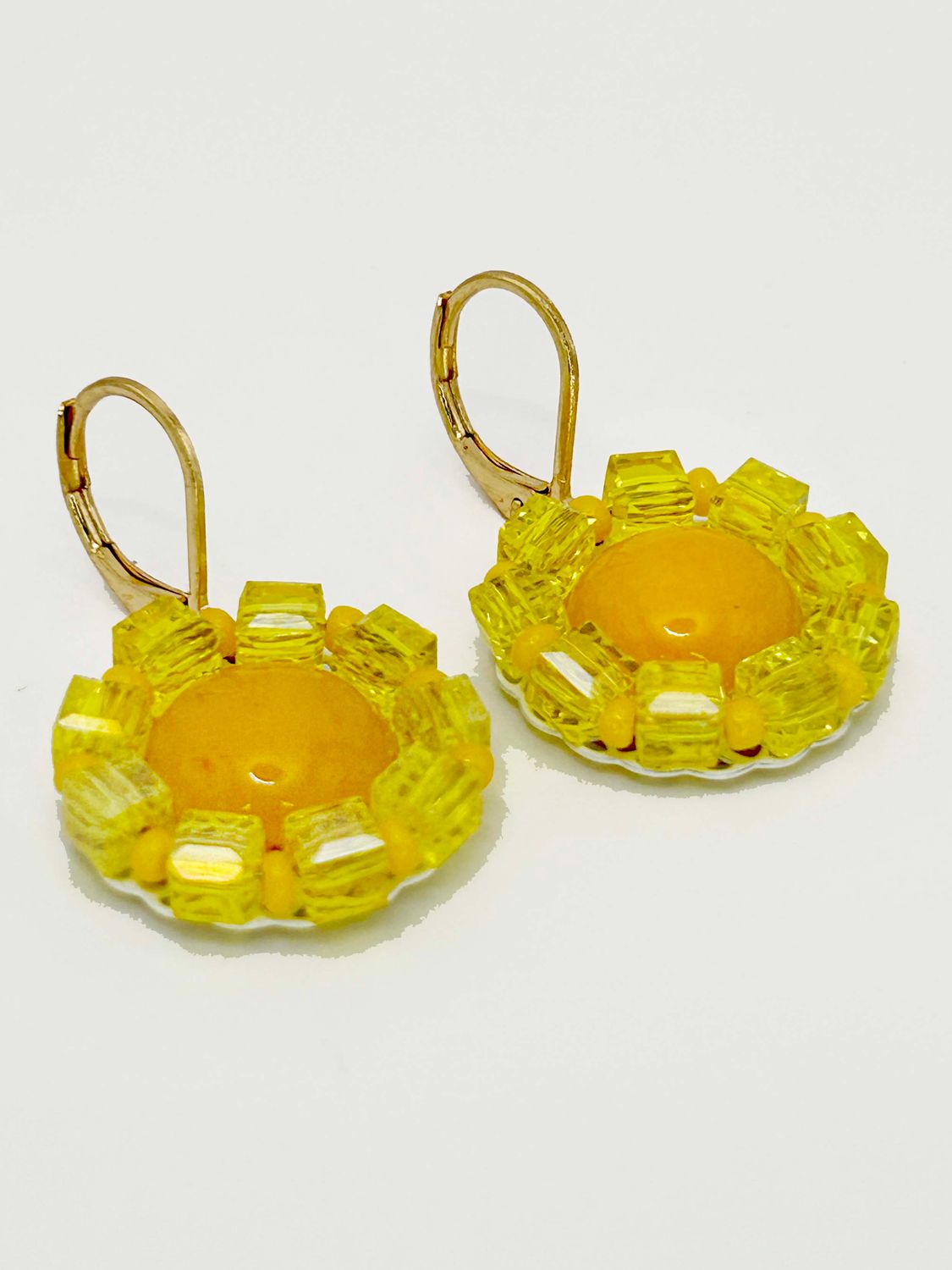 Lulua, gold colored stainless steel ear hook with Topaz.