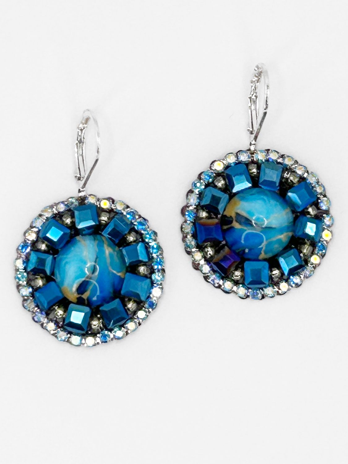 Malua, silver colored stainless steel ear hook with blue fantasy eye.
