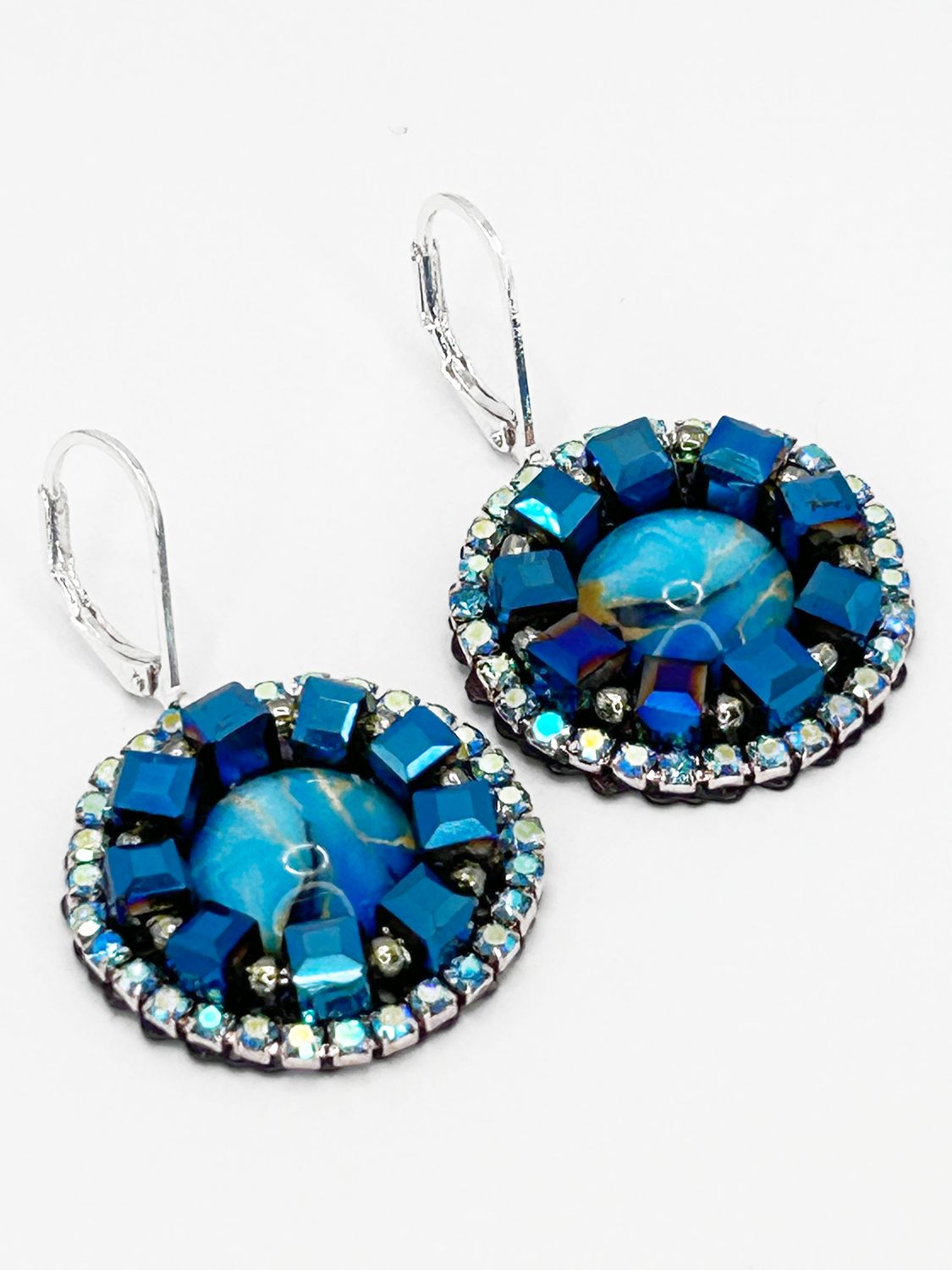 Malua, silver colored stainless steel ear hook with blue fantasy eye.