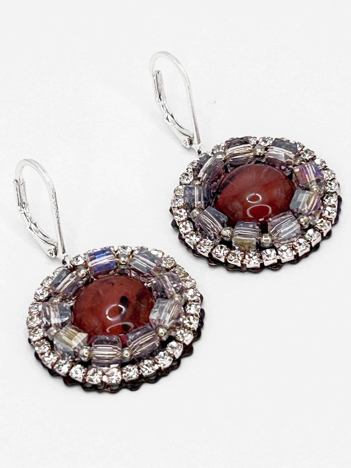 Malua, silver colored stainless steel ear hook with coral colored eye.