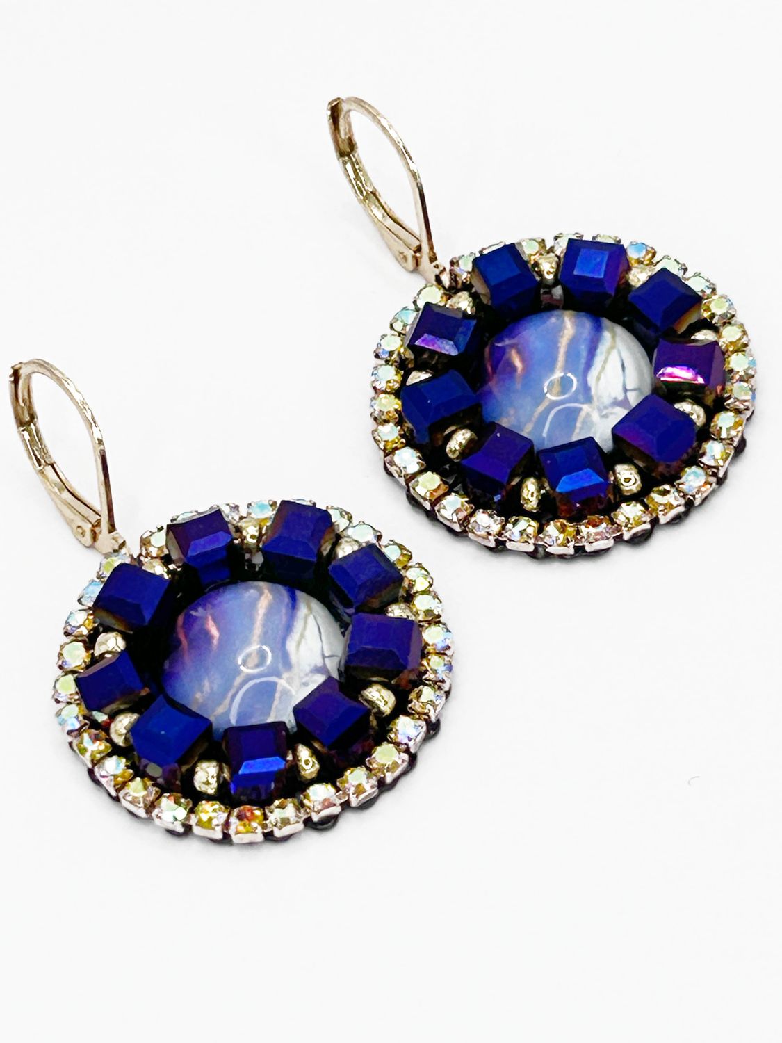 Malua, gold colored stainless steel ear hook with purple fantasy eye.