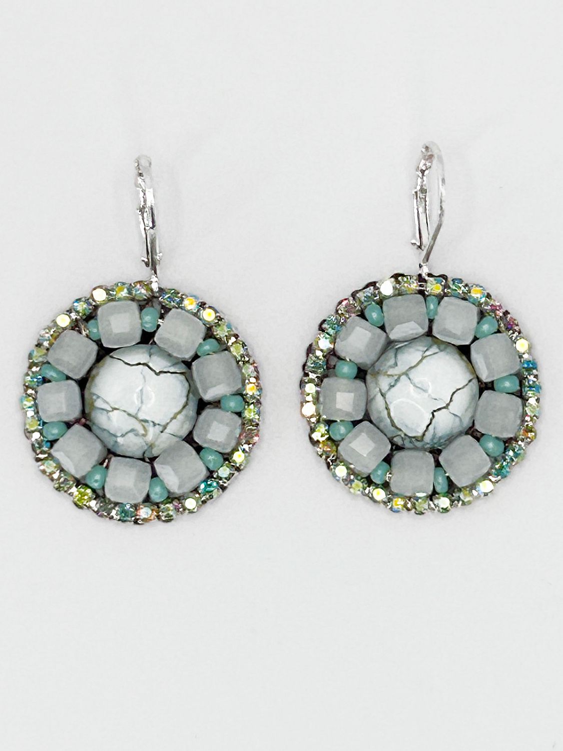 Malua, silver colored stainless steel ear hook with white fantasy eye.