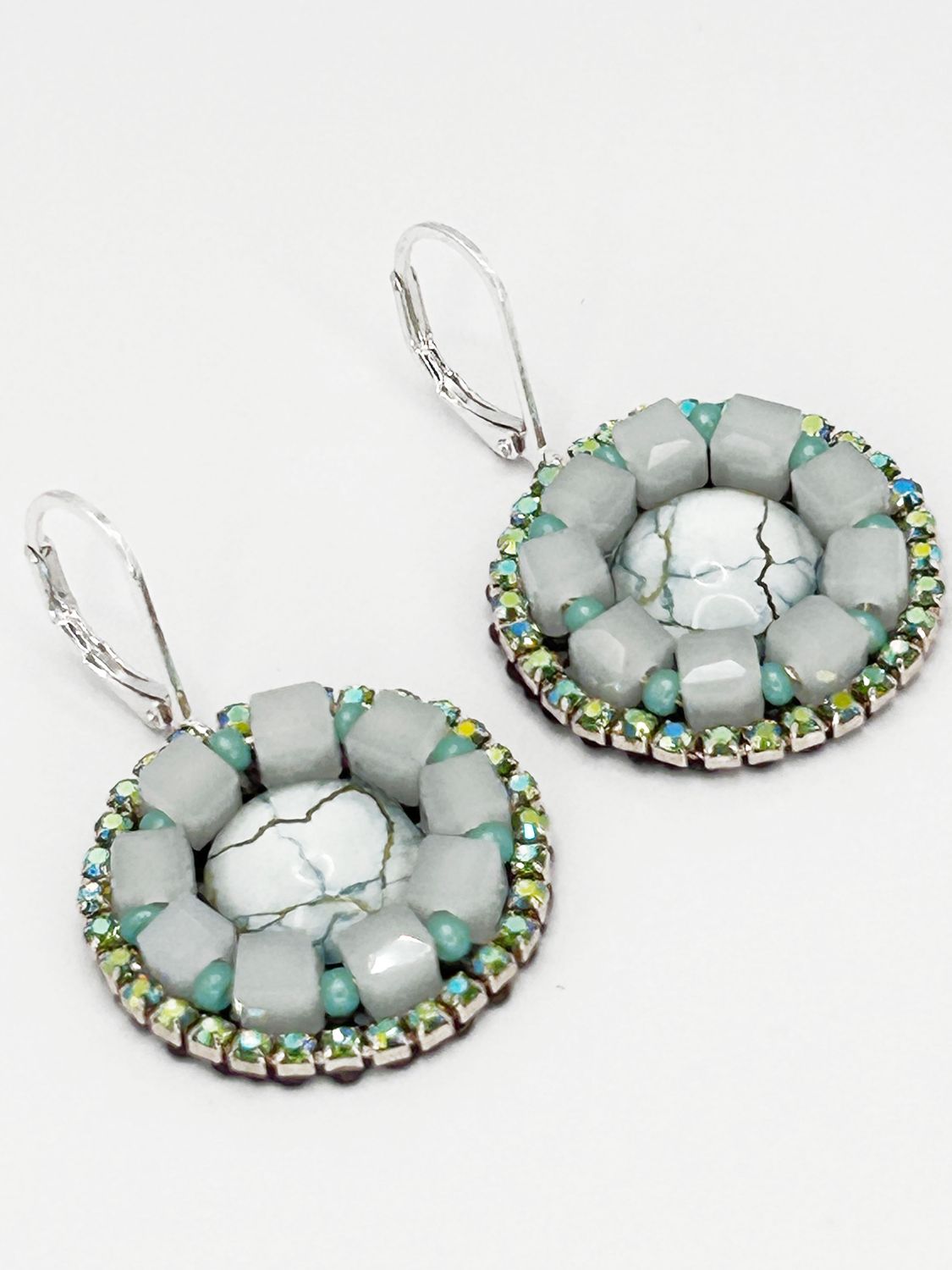 Malua, silver colored stainless steel ear hook with white fantasy eye.