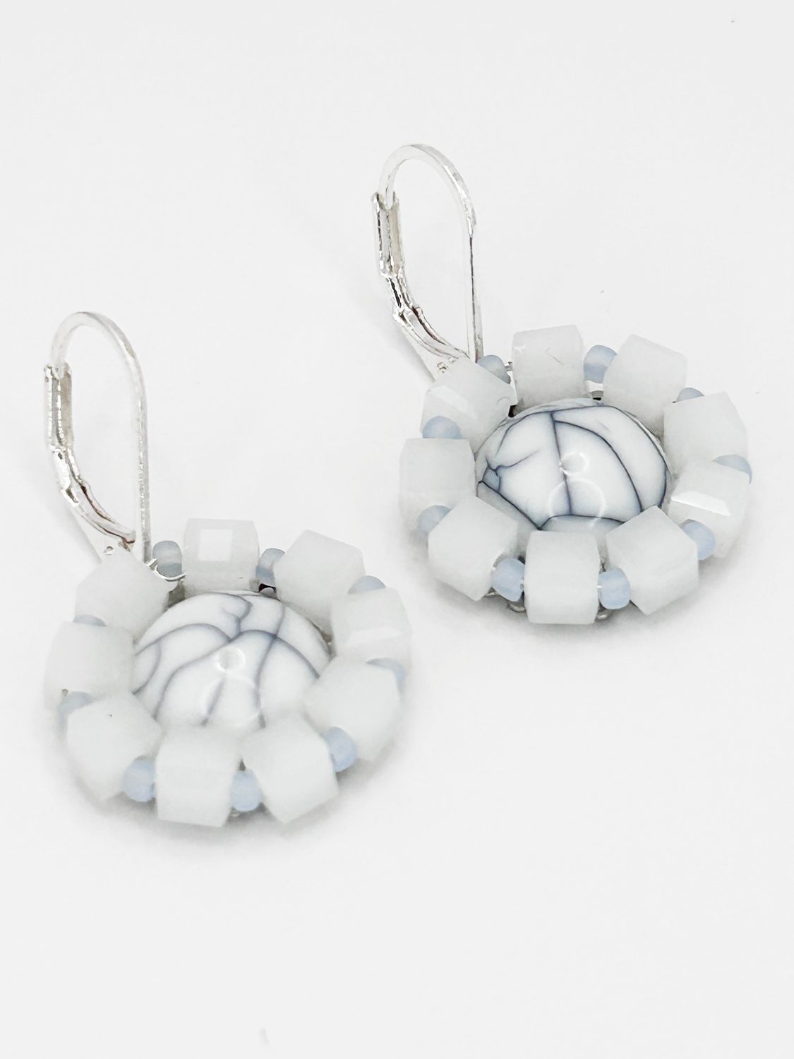Lulua, silver colored stainless steel ear hook with cracked resin.