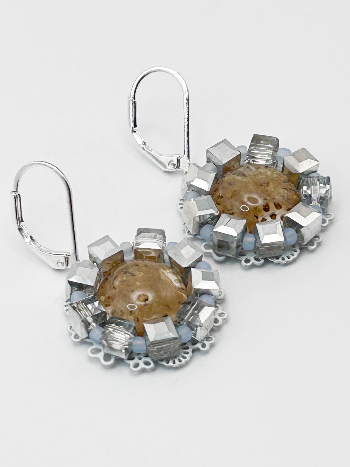 Lulua, silver colored stainless steel ear hook with Golden Healer.