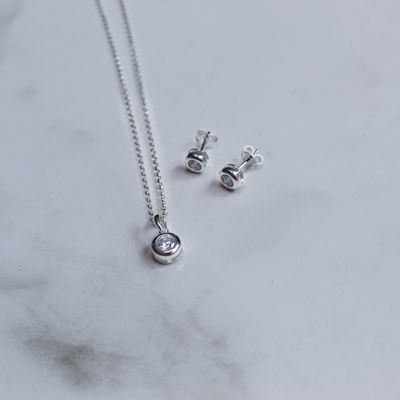 Juego de aretes y dije con zirconia blanca y marco bisel