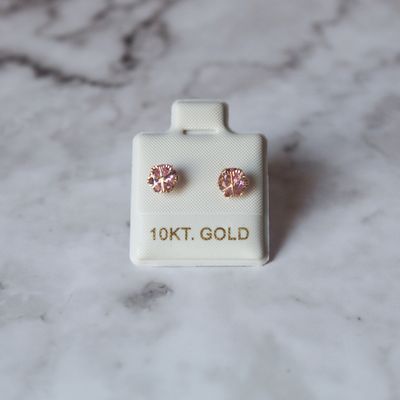 Arete broquel de flor con zirconia color rosada en oro 10KT