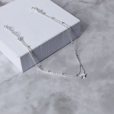 Tobillera doble cadena con detalle de bolitas y estrella