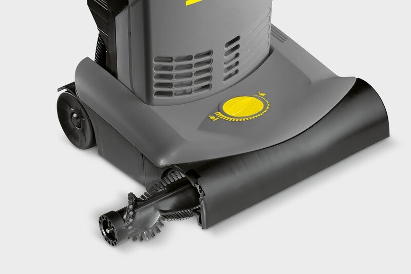 Sliding out the high-torque roller brush assembly tool-free from the deck of a Kärcher CV 30/1 commercial vacuum.