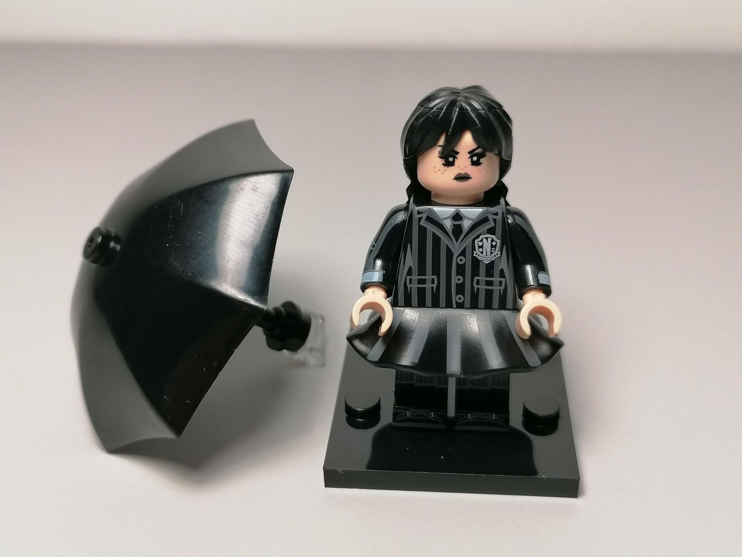 Wednesday minifigure from horror serie Adams family. ​