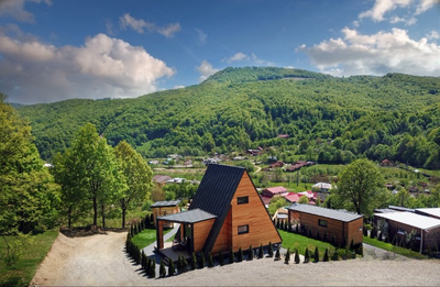 altframe a frame cabin with pergola in a mountain green setting.  used for hospitality and airbnb purposes.  sales@offsetlivingsolutions.com for more information