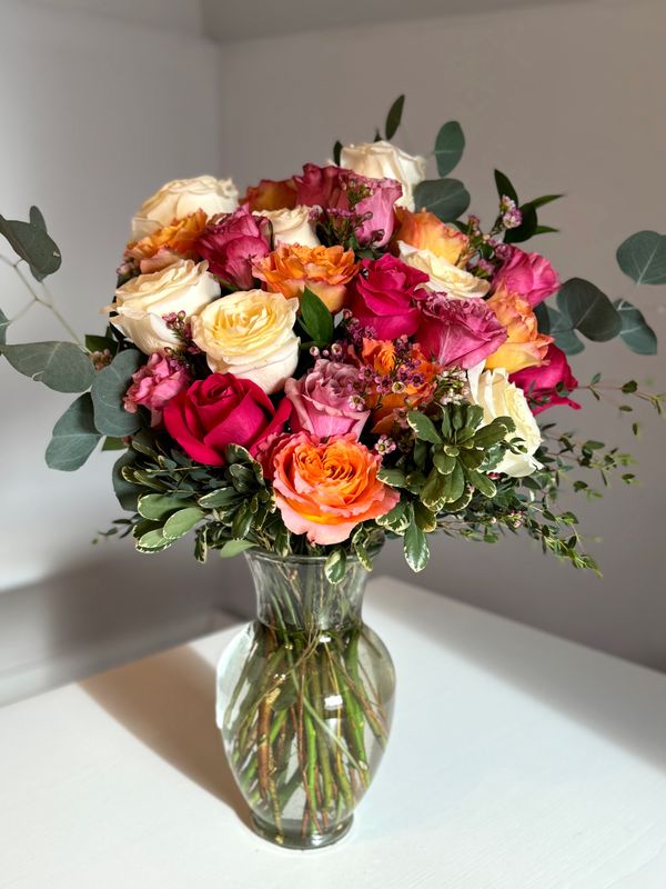 Two Dozen Colourful Roses in a Vase