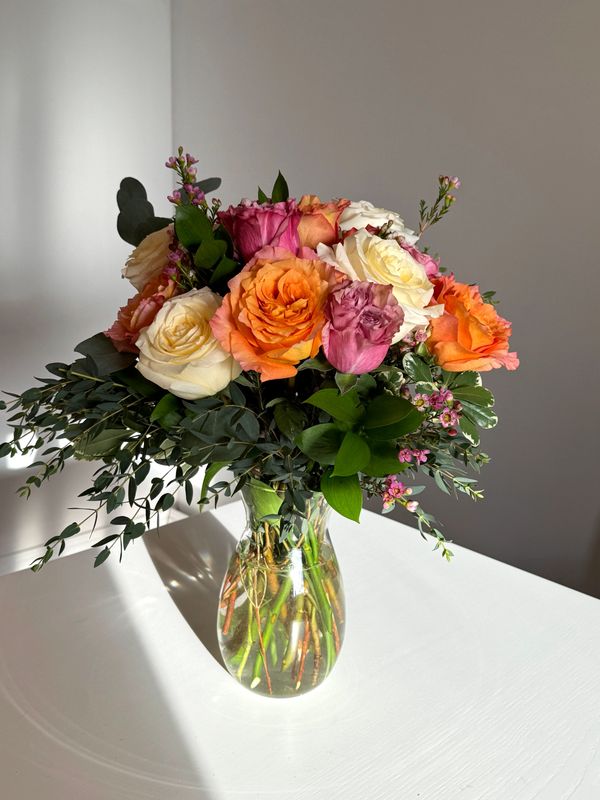 Dozen Colourful Roses in a Vase