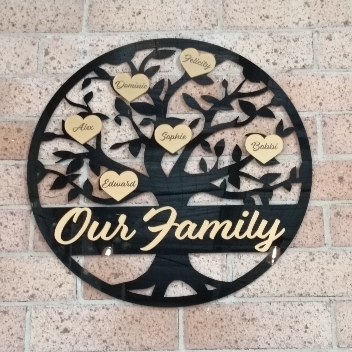 Custom timber family tree wall art with engraved names on hearts or leaves