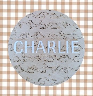Dinosaur-themed custom name wall sign with timber backing, ideal for kids bedroom or nursery.