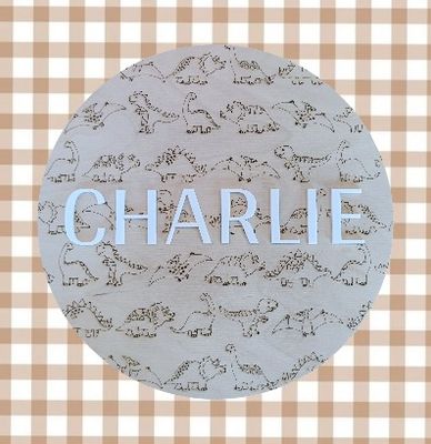 Dinosaur-themed custom name wall sign with timber backing, ideal for kids bedroom or nursery.