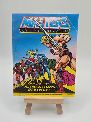 Front cover of the English version of &quot;Hordak - The Ruthless Leader&#39;s Revenge!&quot; 1984 Mini Masters of the Universe Vintage Comic Book Mattel on a stand, featuring He-Man, Hordak, and other characters in action poses.