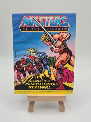 Gros plan sur le coin supérieur droit de la couverture de la bande dessinée Les Maîtres de l&#39;Univers de 1984, montrant Musclor (He-Man) et le titre de la série.