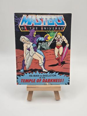 English cover of &#39;He-Man vs Skeletor in the Temple of Darkness&#39; vintage comic book from the Masters of the Universe series, highlighting the Sorceress being kidnapped by Skeletor and He-Man running after them. 