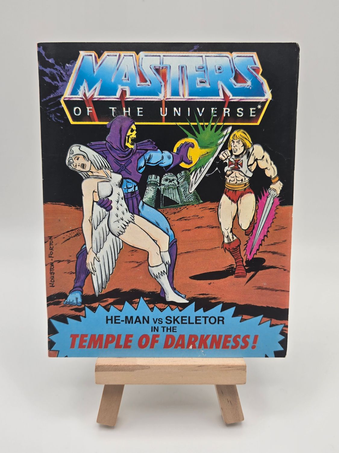 English cover of &#39;He-Man vs Skeletor in the Temple of Darkness&#39; vintage comic book from the Masters of the Universe series, highlighting the Sorceress being kidnapped by Skeletor and He-Man running after them. 